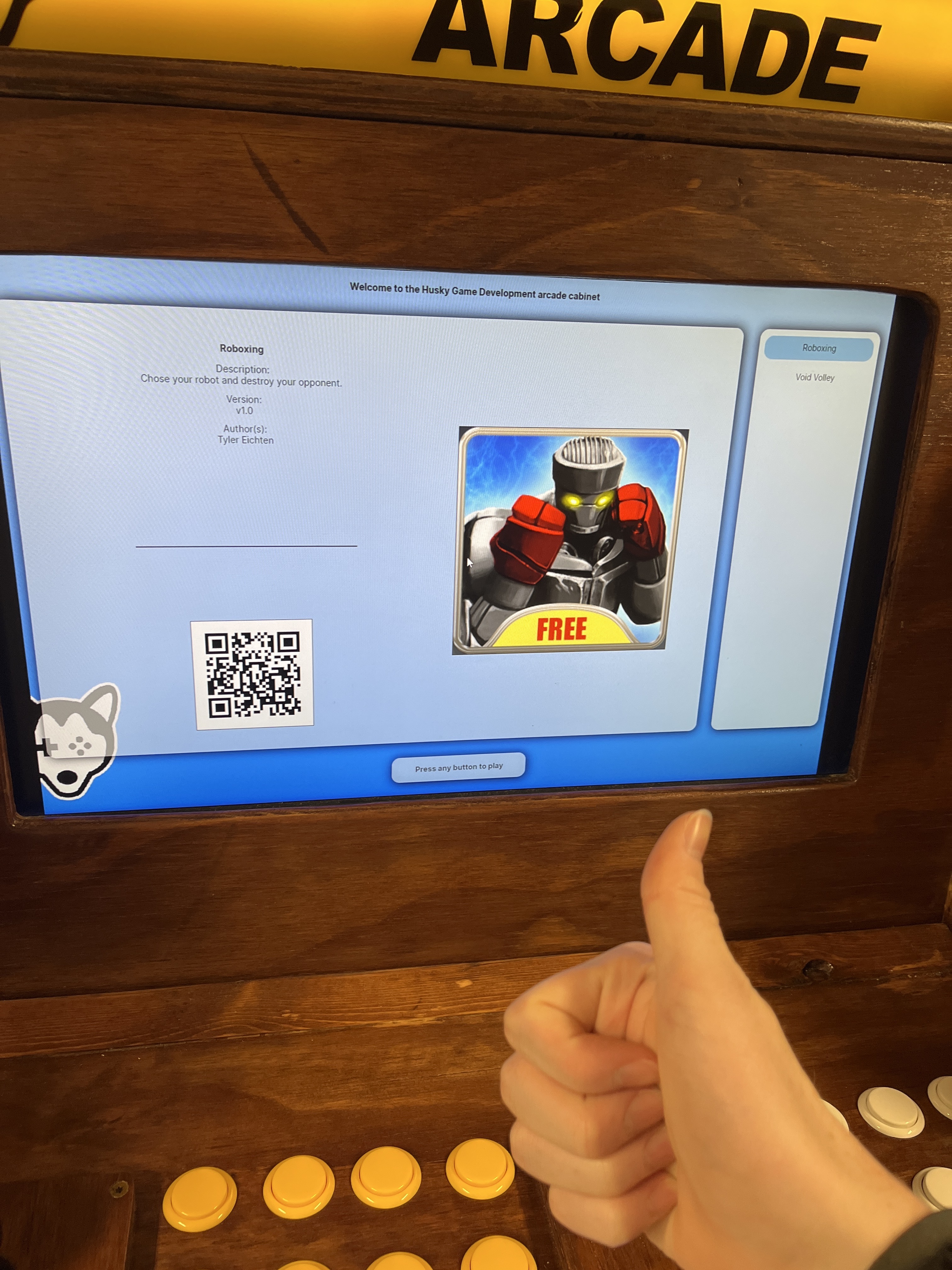 an example image of the cabinet with the new software running on it, the person taking the photo is also giving a thumbs up in front of the camera.